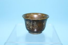 A bronze wine cup, 3.5cm height x 5.5cm width approx.