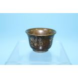 A bronze wine cup, 3.5cm height x 5.5cm width approx.