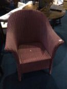 A Lloyd Loom pink armchair