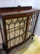 A mahogany bow front china cabinet