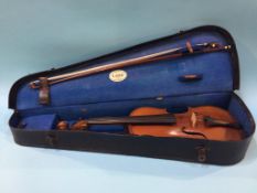 A violin labelled Medio Fino and hard case, 34cm (length of back)