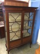An Edwardian mahogany china cabinet, supported on cabriole legs, 116cm width