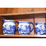 A set of five blue and white graduated jugs