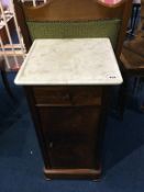 A walnut and white veined marble top bedside cabinet, 40cm width
