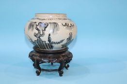 An Oriental bowl on hardwood stand, 23cm height x 21cm width approx.