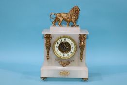 An alabaster mantel clock, surmounted by a lion, 37cm height