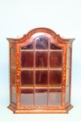 A small Dutch marquetry hanging wall cabinet with domed top, canted sides and three shelves, 60cm