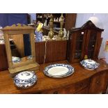 A small two door wall cabinet, mirror and blue and white china etc.