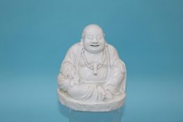 A Blanc de Chine Buddha, 16cm height x 14cm width approx.