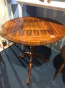 A reproduction mahogany chess top table by D. M. Christian, the top crossbanded, below a bird cage
