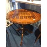 A reproduction mahogany chess top table by D. M. Christian, the top crossbanded, below a bird cage