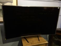A Samsung Curve TV, with stand and remote SUHD (approx. 66")