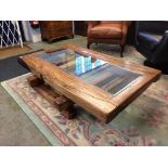 A large drift wood style coffee table with glass centre, 150cm x 90cm