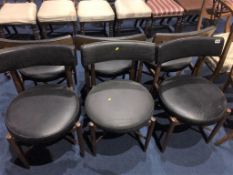 A set of six G Plan teak chairs, with black vinyl circular seats