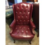 An oxblood leather Chesterfield style armchair