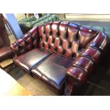 An oxblood leather Chesterfield two seater settee