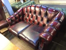 An oxblood leather Chesterfield two seater settee