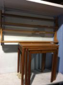 An Ercol delft rack and teak nest of tables