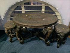 An oval carved elephant table, with two small elephant tables (3)