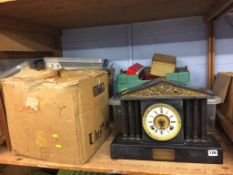 A shelf of assorted, to include a slate mantle clock, train set and stamps