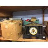 A shelf of assorted, to include a slate mantle clock, train set and stamps