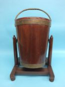 A 19th century mahogany Irish peat bucket on a swivel stand by James Hicks of 5 Lower Pembroke