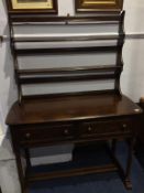 An Ercol two drawer side table with delft rack, 112cm wide