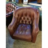 A brown leather button back chair by Laura Ashley