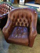 A brown leather button back chair by Laura Ashley