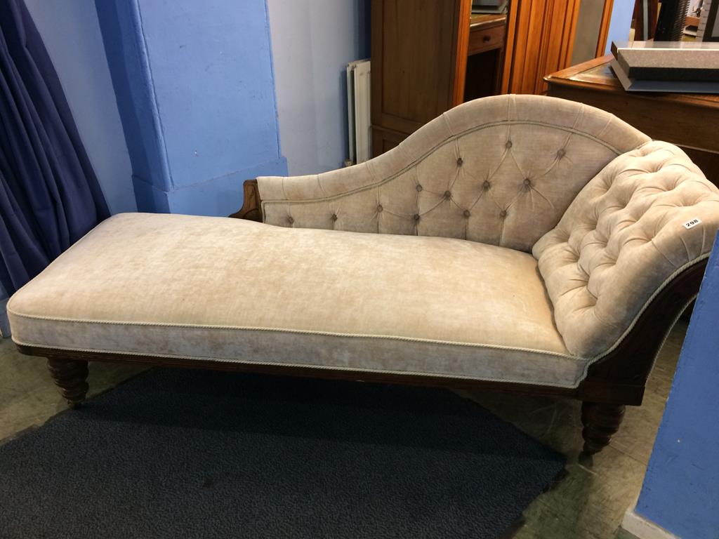 An Edwardian walnut framed and buttoned chaise longue