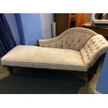 An Edwardian walnut framed and buttoned chaise longue