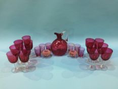 A collection of cranberry glass