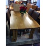 A bespoke light oak dining table by Mark Talbot and six modern chairs