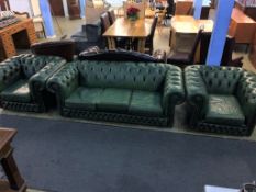 A green leather Chesterfield three seater settee and pair of armchairs