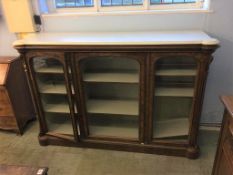 A Victorian marble top walnut three door side cabinet, the white marble top below three glazed