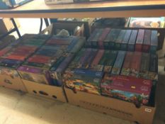 A large quantity of jigsaw puzzles, in four boxes