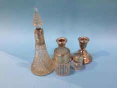 Silver top scent bottles and candlesticks etc.