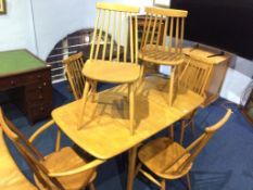 An Ercol drop flap table, a pair of spindle back Ercol carvers and a pair of single chairs and two