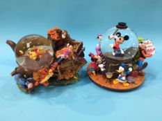 Two boxed Disney snow globes