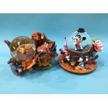 Two boxed Disney snow globes