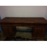 A 19th century mahogany sideboard with lift up top, having heavy brass supports and fold away shelf,