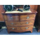 A Georgian mahogany bow front chest of drawers with two short and two long graduated drawers,