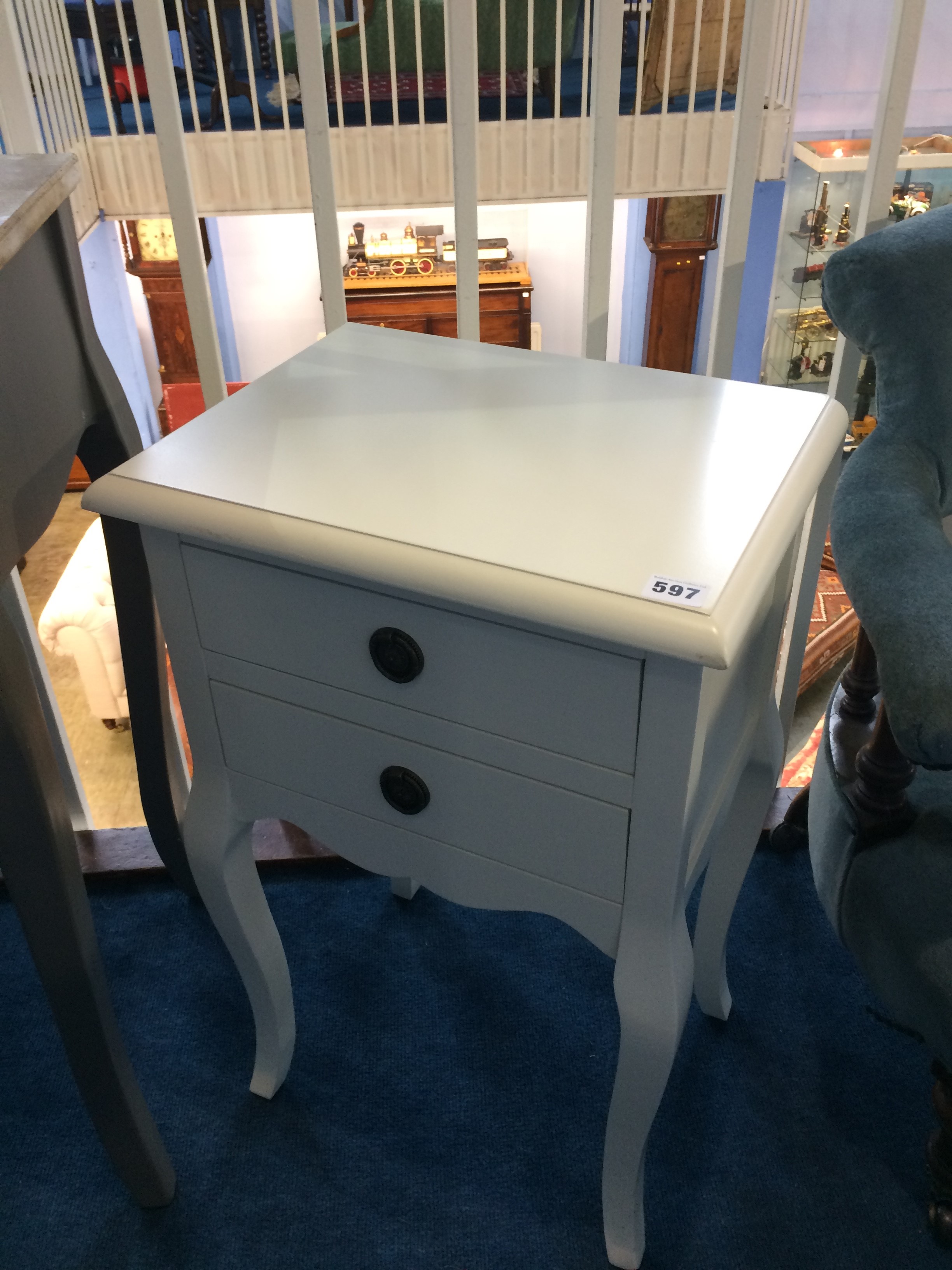 A pair of cream bedside tables