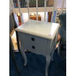 A pair of cream bedside tables