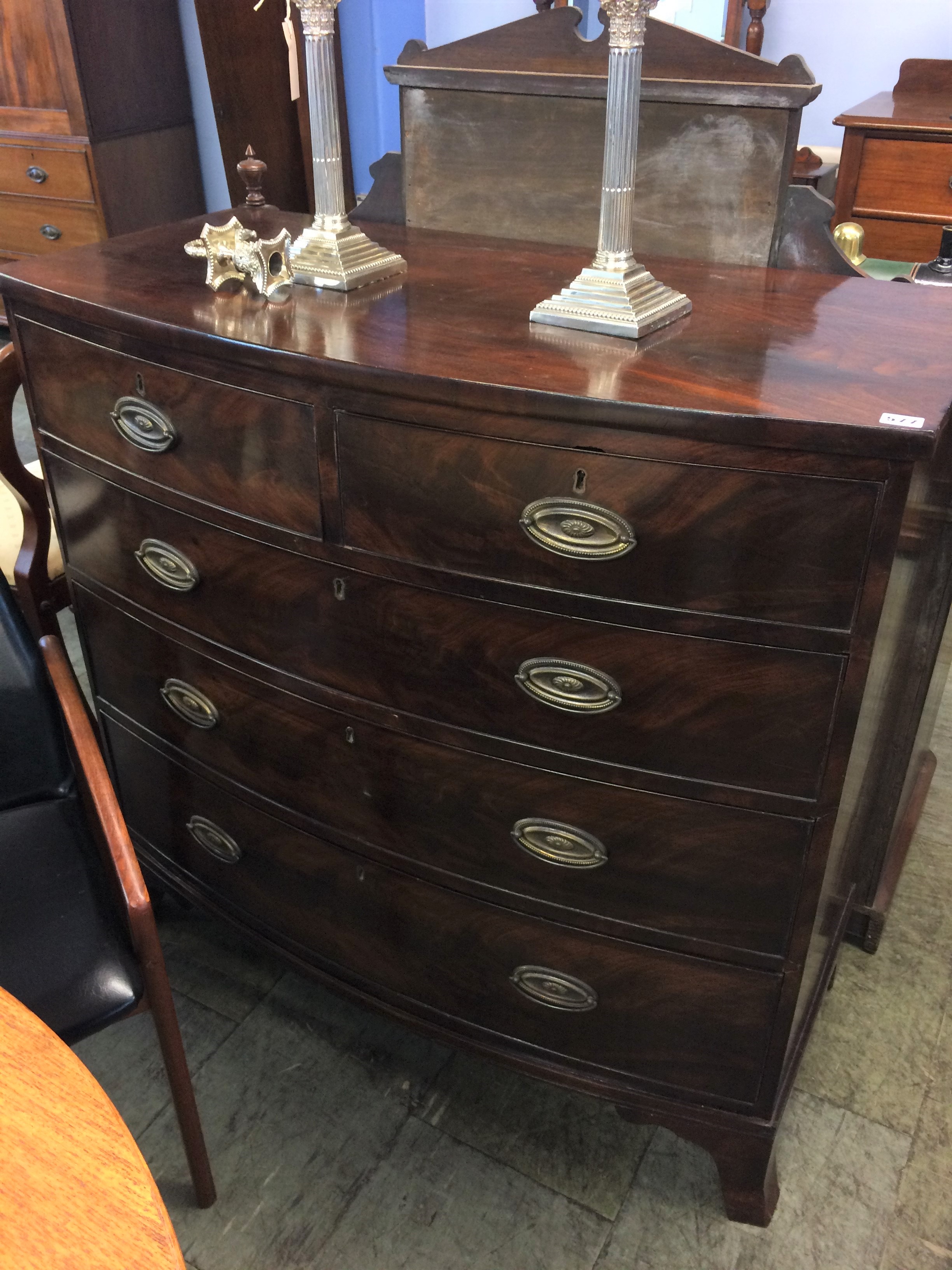 A Georgian mahogany bow front chest of drawers, with two short and three long graduated drawers,