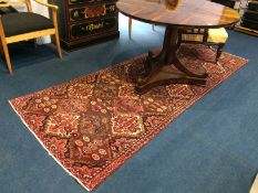 A Hamadan rug, with all-over geometric tree and floral design in red and blue. 270cm long x 110cm