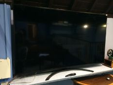 A wall mounted 75" LG NanoCell TV, with remote. Model number 75SM8610PLA.