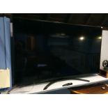 A wall mounted 75" LG NanoCell TV, with remote. Model number 75SM8610PLA.