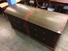 A large Continental pine domed top trunk, with two handles and decorated in green and reds. 142cm