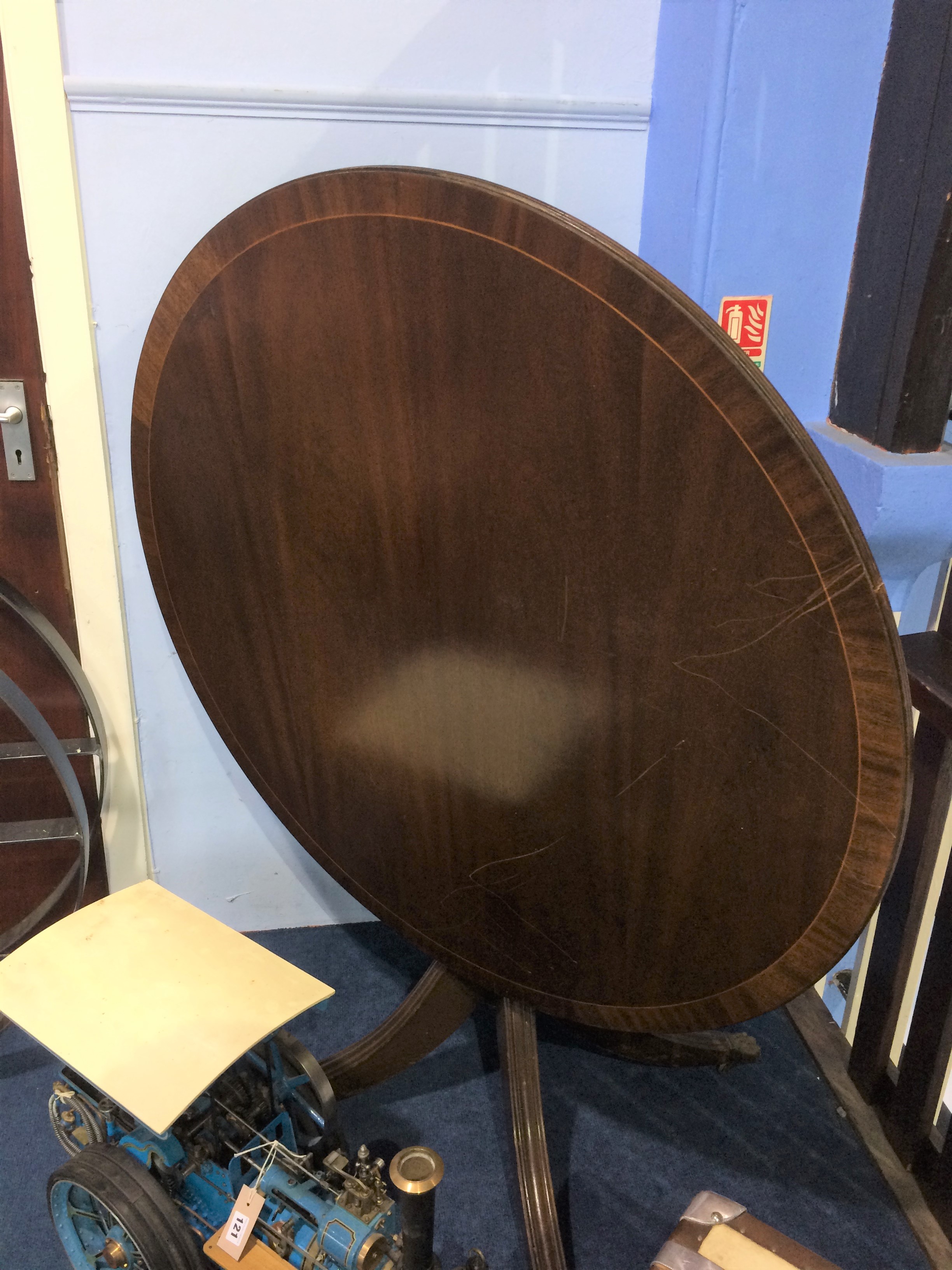 A reproduction mahogany circular table